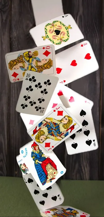 Artistic cascade of playing cards on wooden background.