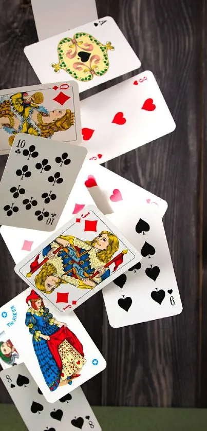 Artistic cascade of vintage playing cards on a dark wooden background.