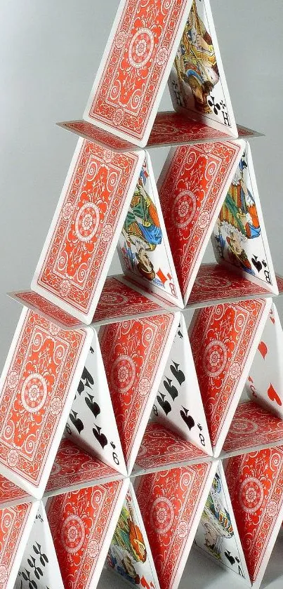 A pyramid of red and white playing cards neatly stacked.