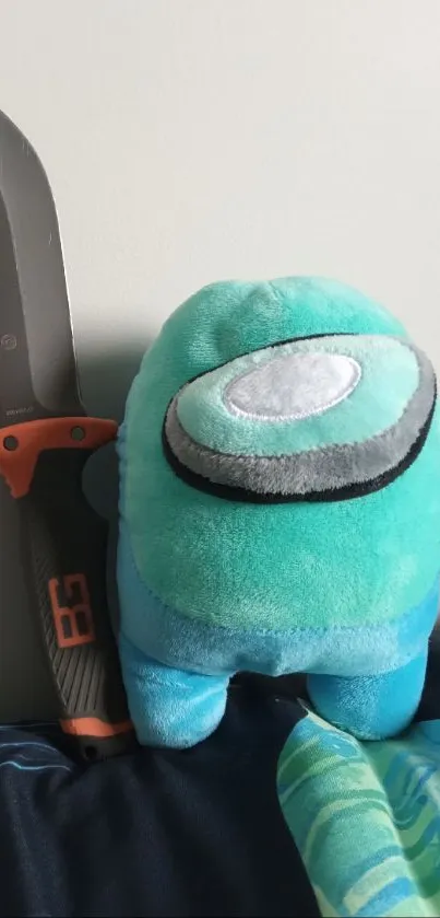 Mobile wallpaper of a turquoise plush toy and knife against a gray background.