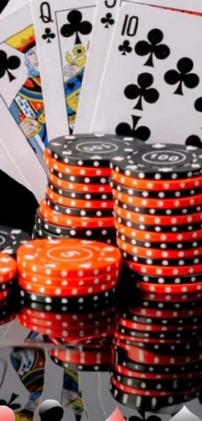 Poker cards and colorful chips on a reflective surface.