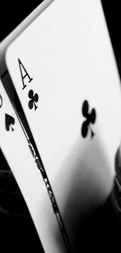 Black and white poker cards with chips in focus.