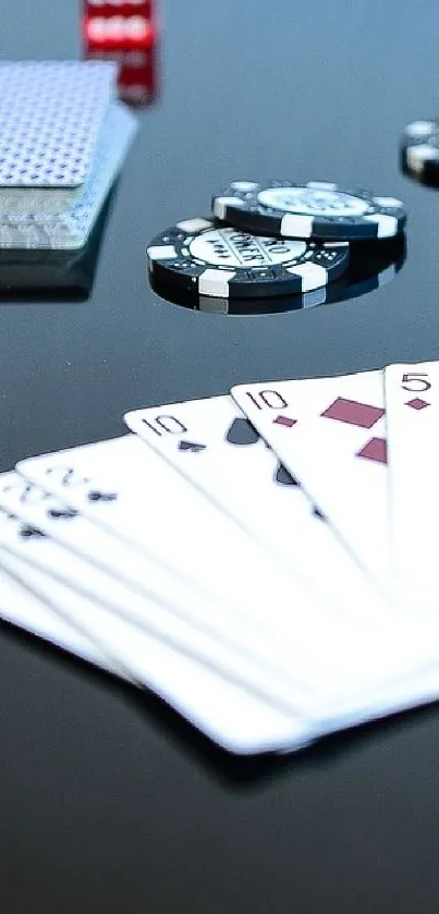 Poker chips and playing cards on a black background, with red dice scattered.