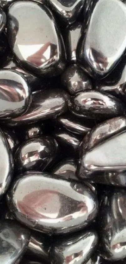 Glossy polished hematite stones close-up.