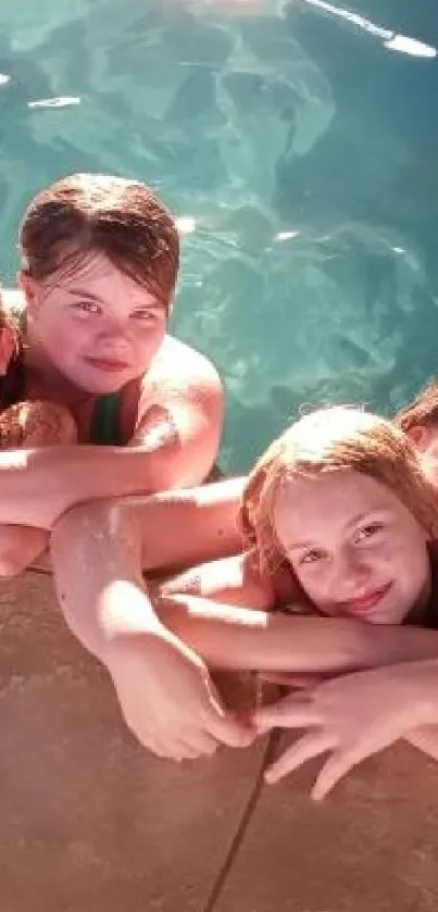 Group of friends smiling by the sunny poolside on a summer day.