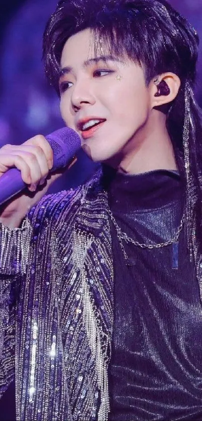 Pop star singing on stage with a sparkly jacket and microphone.