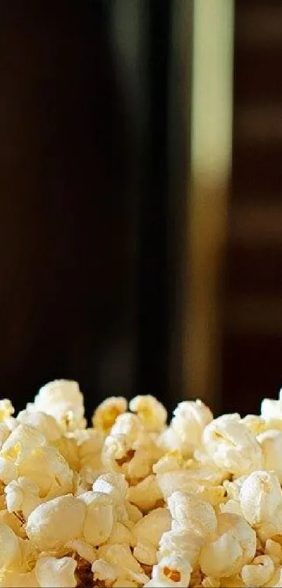 Close-up of buttery popcorn on a dark background.