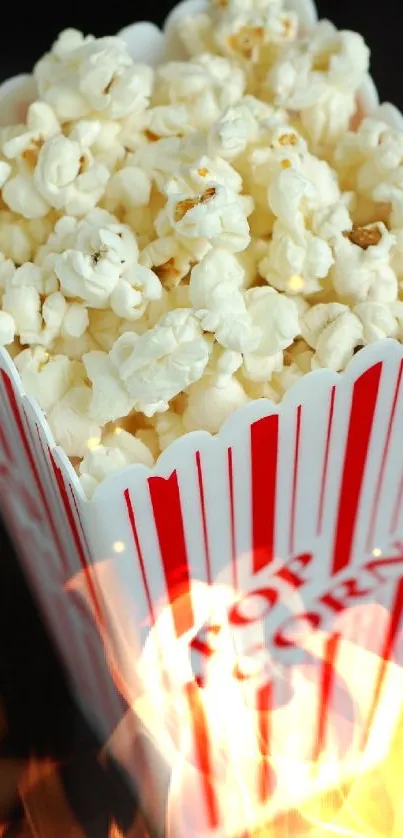 Popcorn in a red and white striped box, perfect for movie lovers.