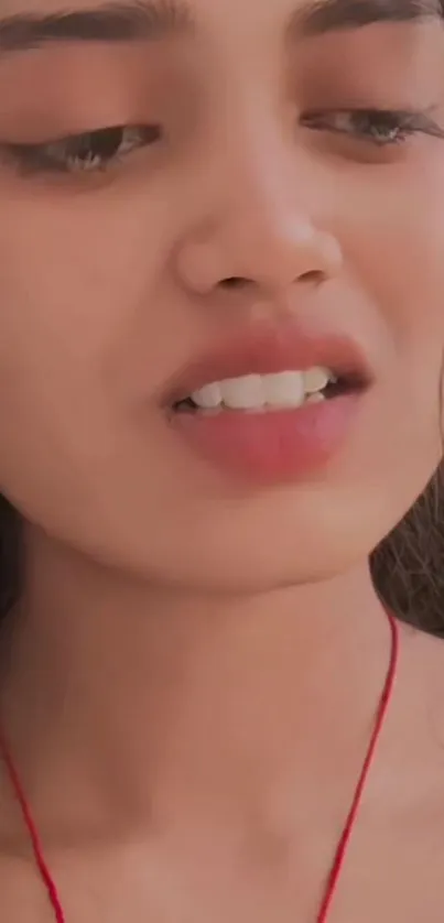 Close-up portrait of a woman with a thoughtful expression.