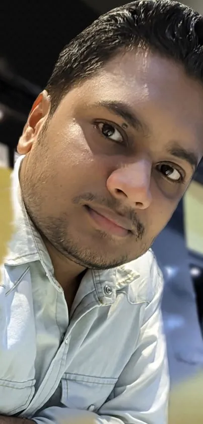 Close-up portrait of a young person in a casual indoor setting.