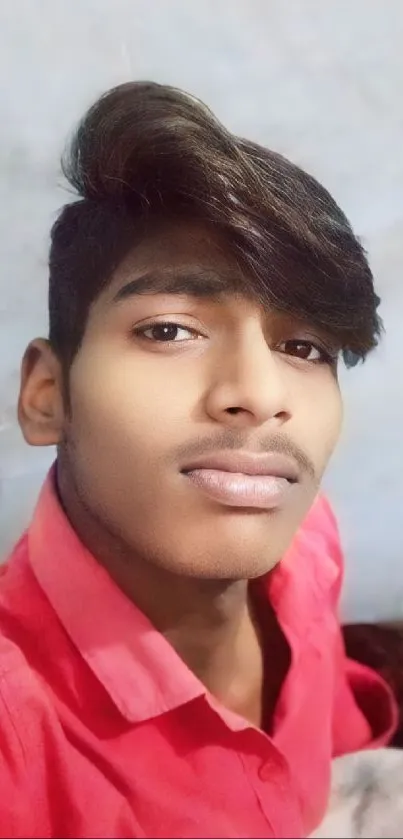 Portrait of a young man in a red shirt.