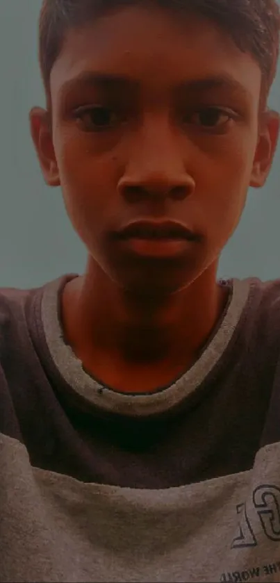 Portrait of a young boy outdoors with a serene expression.
