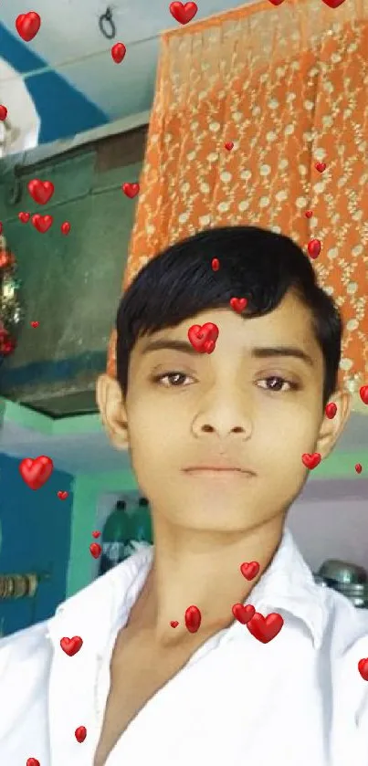 Young person posing indoors with colorful orange curtain.