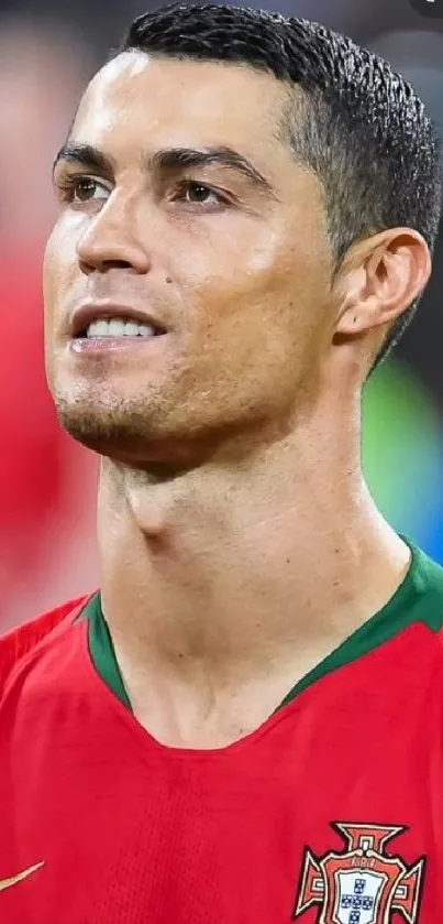 Portugal soccer star in red jersey smiling.