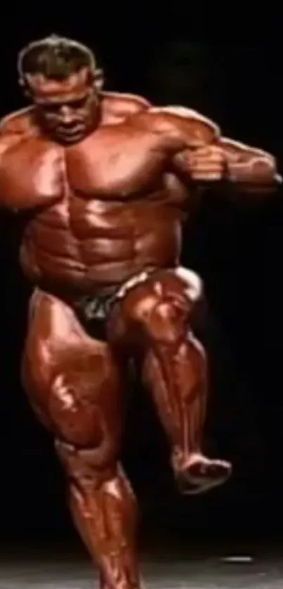 Muscular bodybuilder posing on stage with dark background.