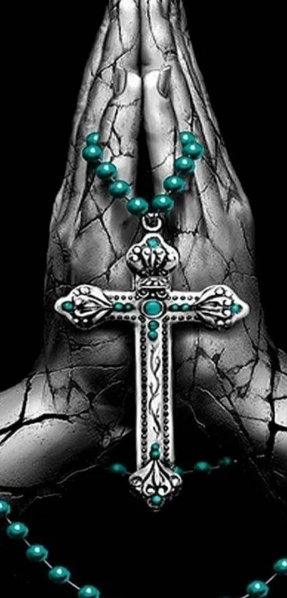 Cracked hands with turquoise rosary and cross on black wallpaper.