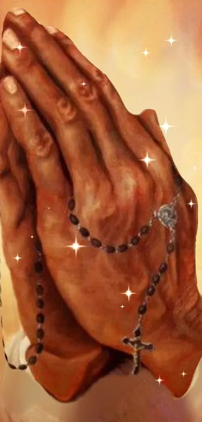 Praying hands holding a rosary, illuminated by a warm glow with sparkles.