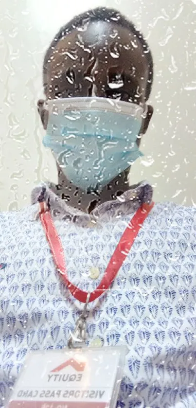 Professional in printed shirt with ID badge and face mask.