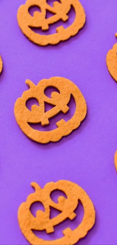 Colorful pumpkins on a purple Halloween wallpaper pattern.