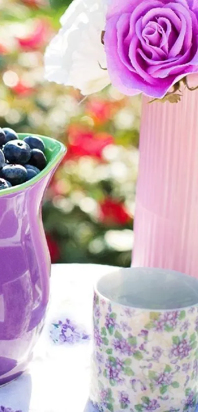Purple pitcher of berries with flowers on table.