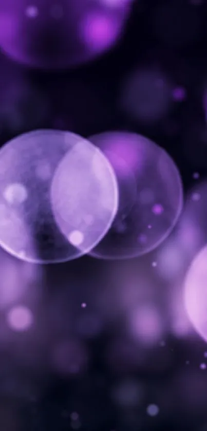 Purple bokeh wallpaper with bubbles and blurred circles.