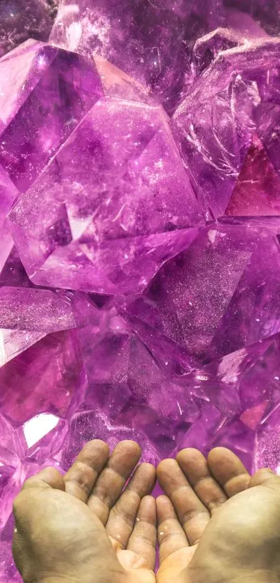 Hands holding vibrant purple crystals in serene wallpaper.