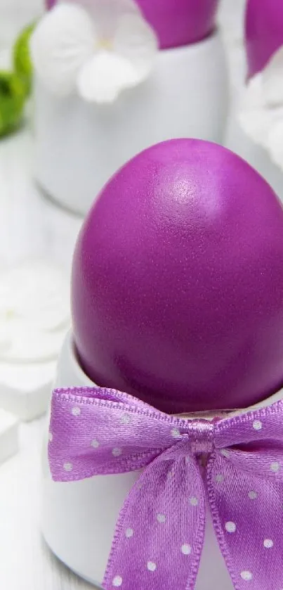 Purple Easter egg with ribbon and white flowers on a bright background.