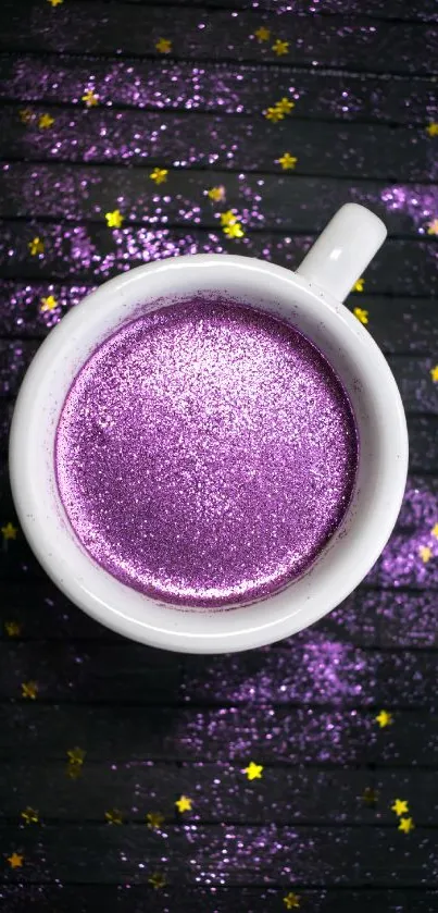 Glittery purple coffee cup with stars on dark wood.