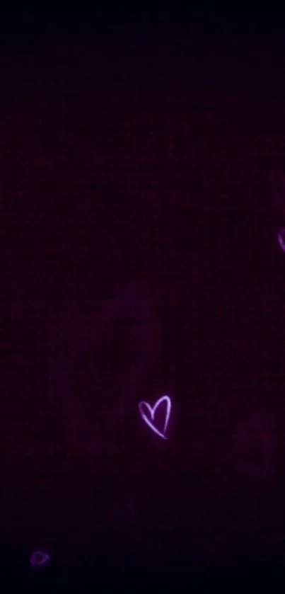 Neon hearts on a dark purple background creating a romantic aesthetic.