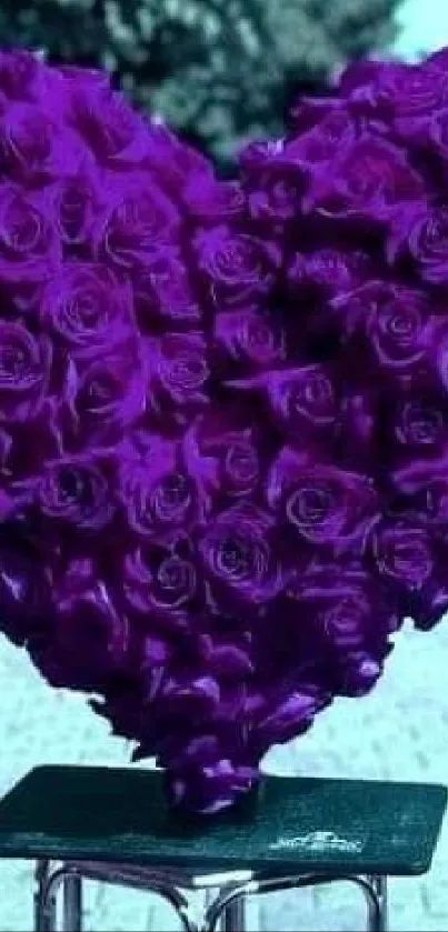 Heart-shaped purple rose bouquet on a stand.