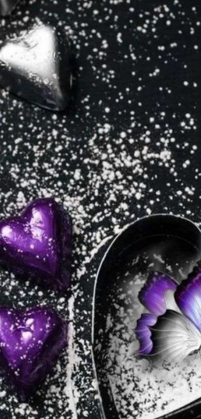 Purple hearts and butterfly on dark background, sprinkled with white dust.