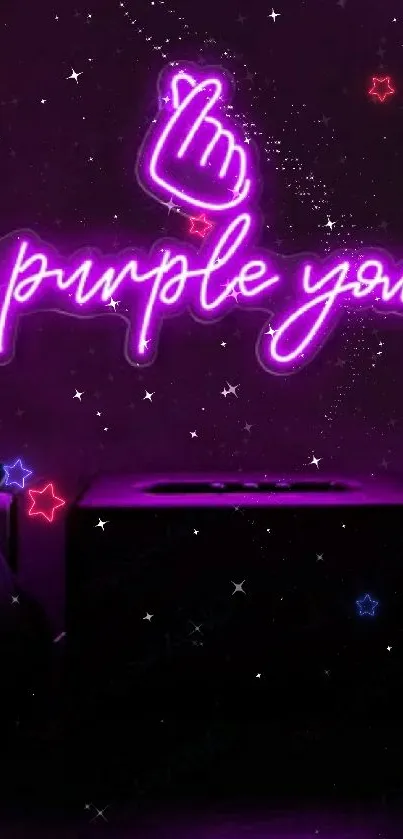 Neon purple sign 'I purple you' on a dark wall background.