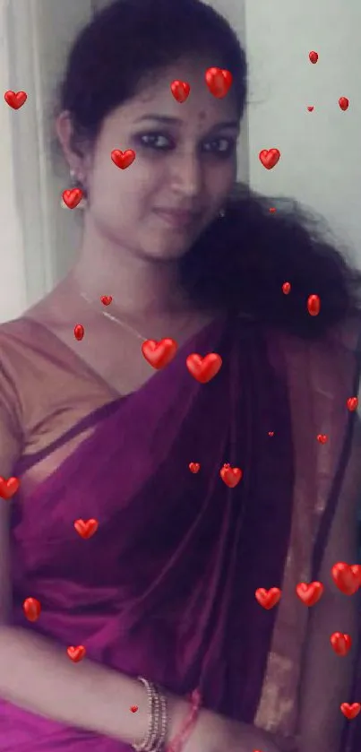 Woman in purple saree with red hearts background.