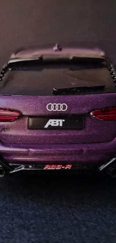 Rear view of a purple Audi car in shadowed setting.