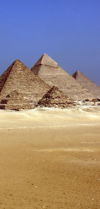 Desert pyramids at Giza with clear blue sky.