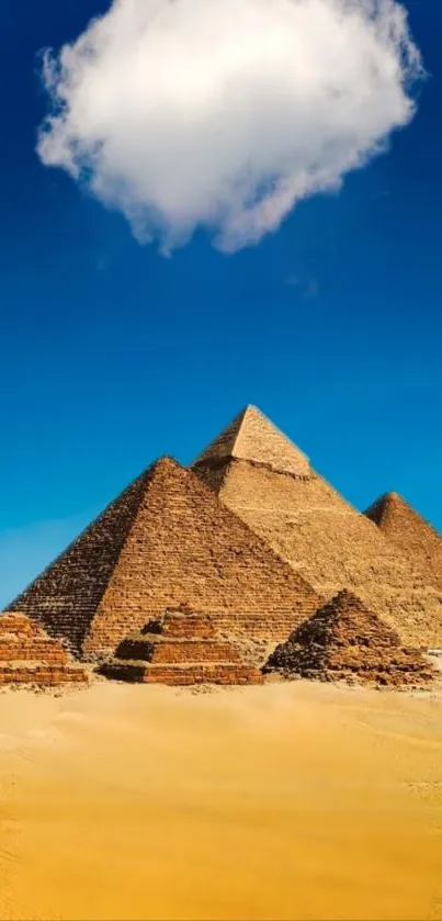 Egyptian pyramids under a blue sky with a cloud, set in a desert landscape.