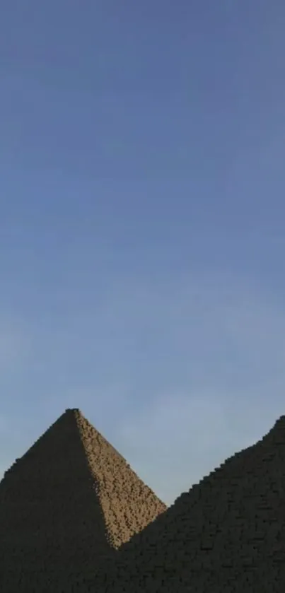 Ancient pyramids beneath expansive blue sky.