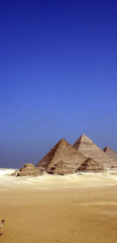 Majestic pyramids under a vibrant blue sky in the desert, perfect for mobile wallpaper.