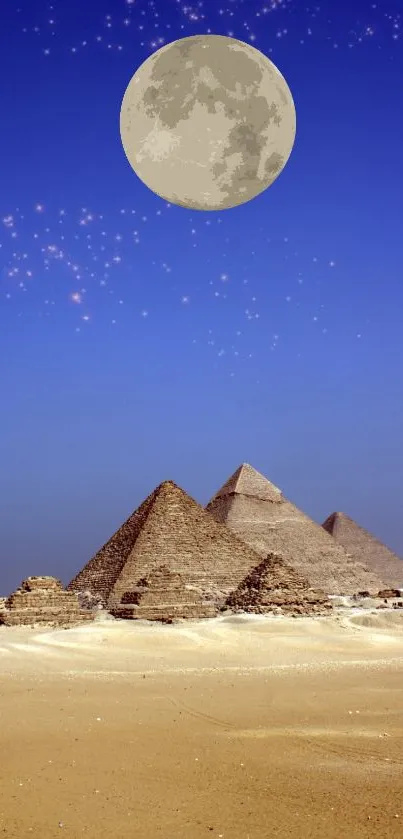 Pyramids in Egypt under a full moon and starry sky.