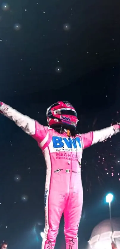 Racer in a pink suit celebrating under starry sky.