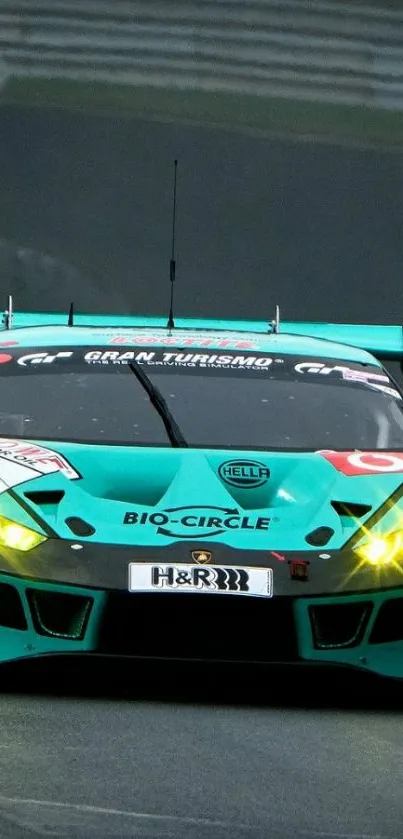 Green racing car on track with headlights on.