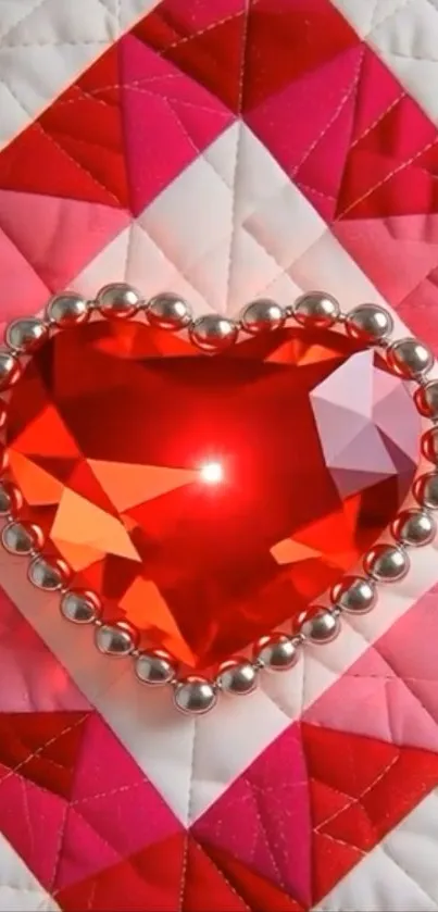 Heart-shaped red gemstone with silver beads on a pink quilt pattern.
