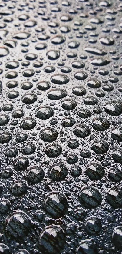 High-resolution rain droplets on a textured gray-blue surface.