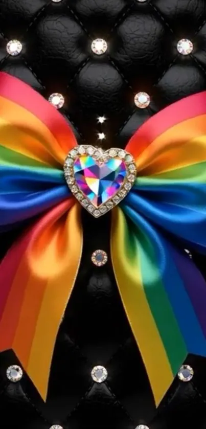 Rainbow heart bow against black leather with diamonds.