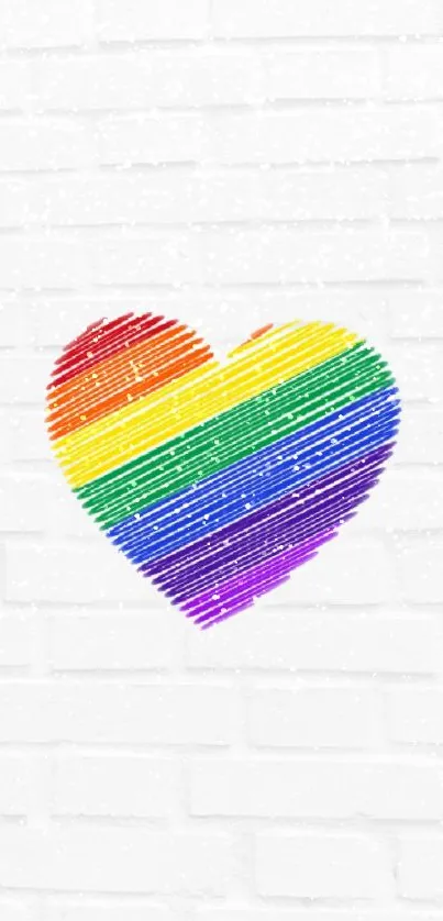 Vibrant rainbow heart on a textured white wall background.