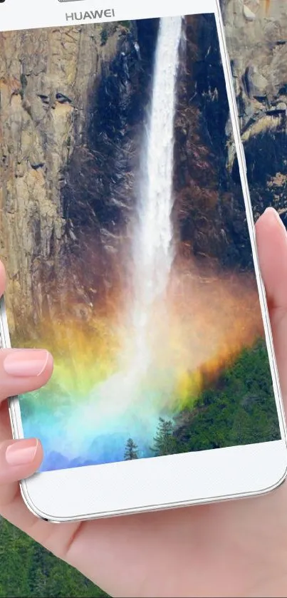 Hand holding phone displaying a rainbow waterfall.