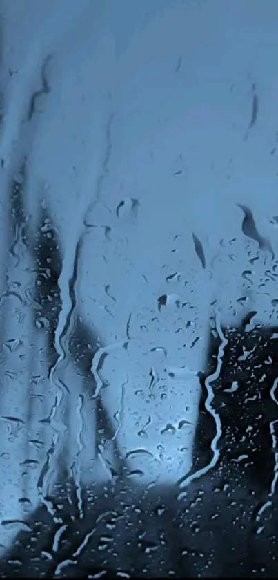 Raindrop covered glass with soothing blue hue for a serene phone wallpaper.