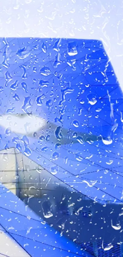 Blue airplane wing with raindrops, perfect for travel-themed wallpapers.