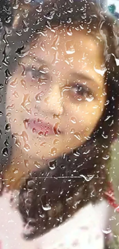 Portrait with raindrop effect on a glass surface, creating an artistic visual.