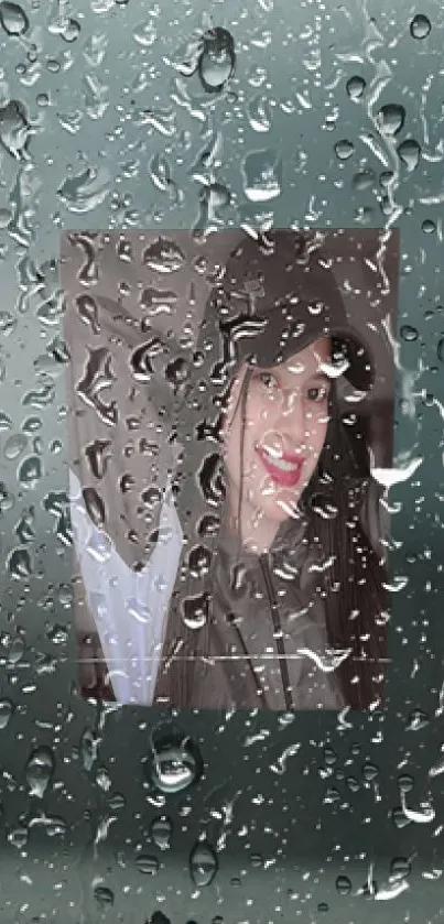 Rain-covered glass with a portrait behind.